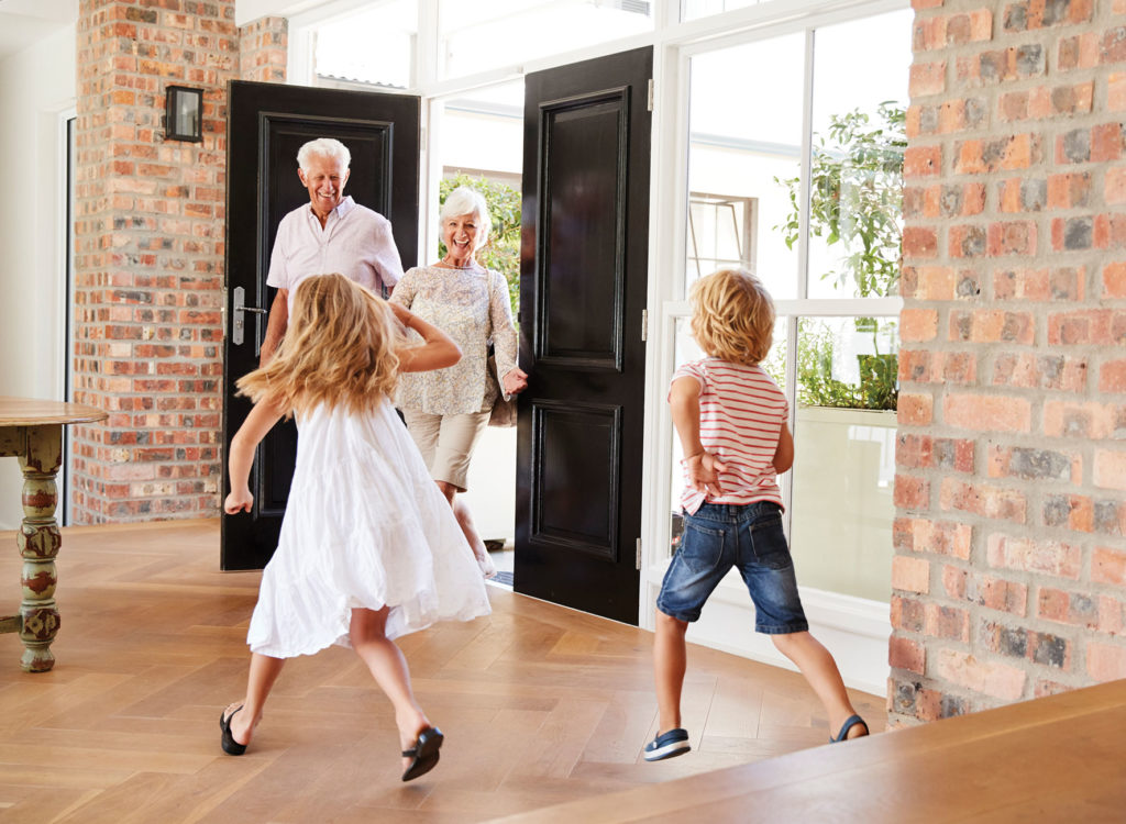 Kids greeting grandparents at estate entrance